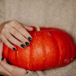 photo of woman holding a pumpkin